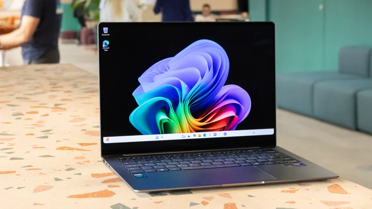 The Samsung Galaxy Book5 Pro pictured on a worktop from the left side, open