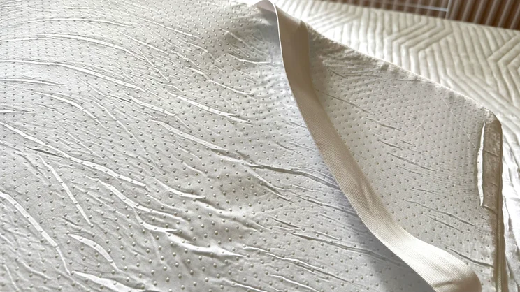 A closeup of the corner of the Origin Contour Mattress Topper